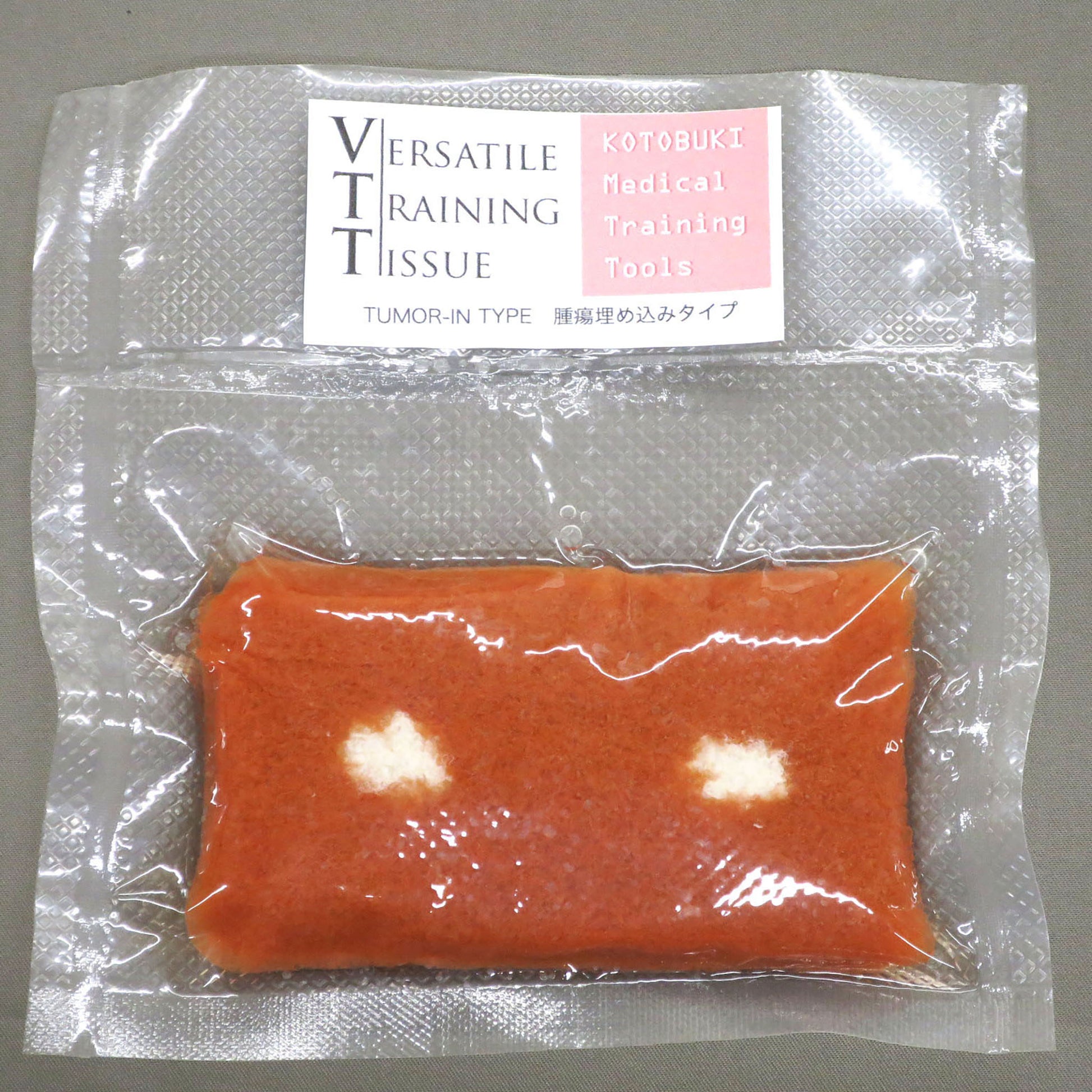 The VTT Tumor Type in its shrink-wrapped packaging against a gray background. 